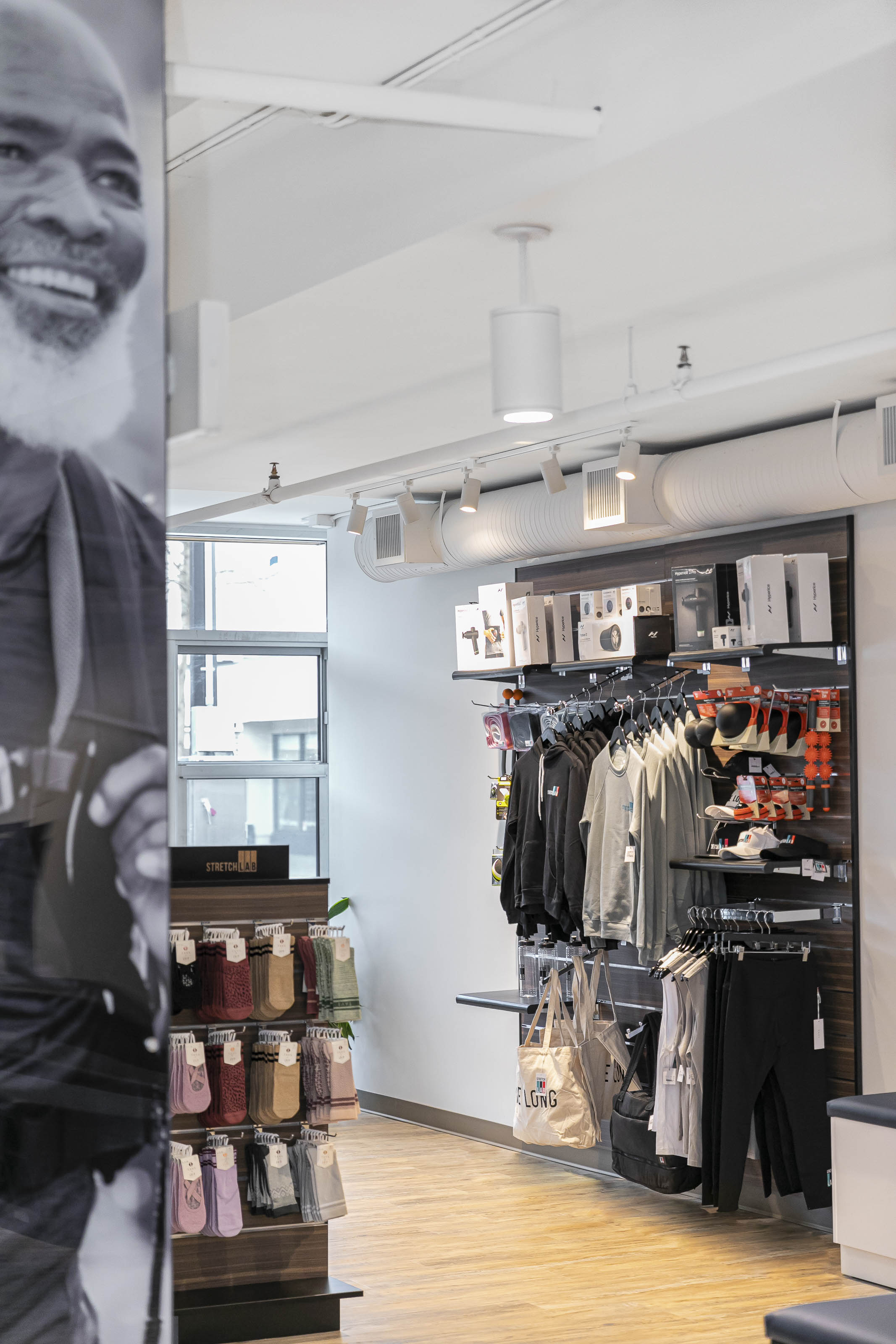 Custom stretching studio renovation Victoria BC - Stretch Lab commercial tenant improvement by Outlook Project Management with built-in workout benches, motivational wall graphics, and modern fitness facility design