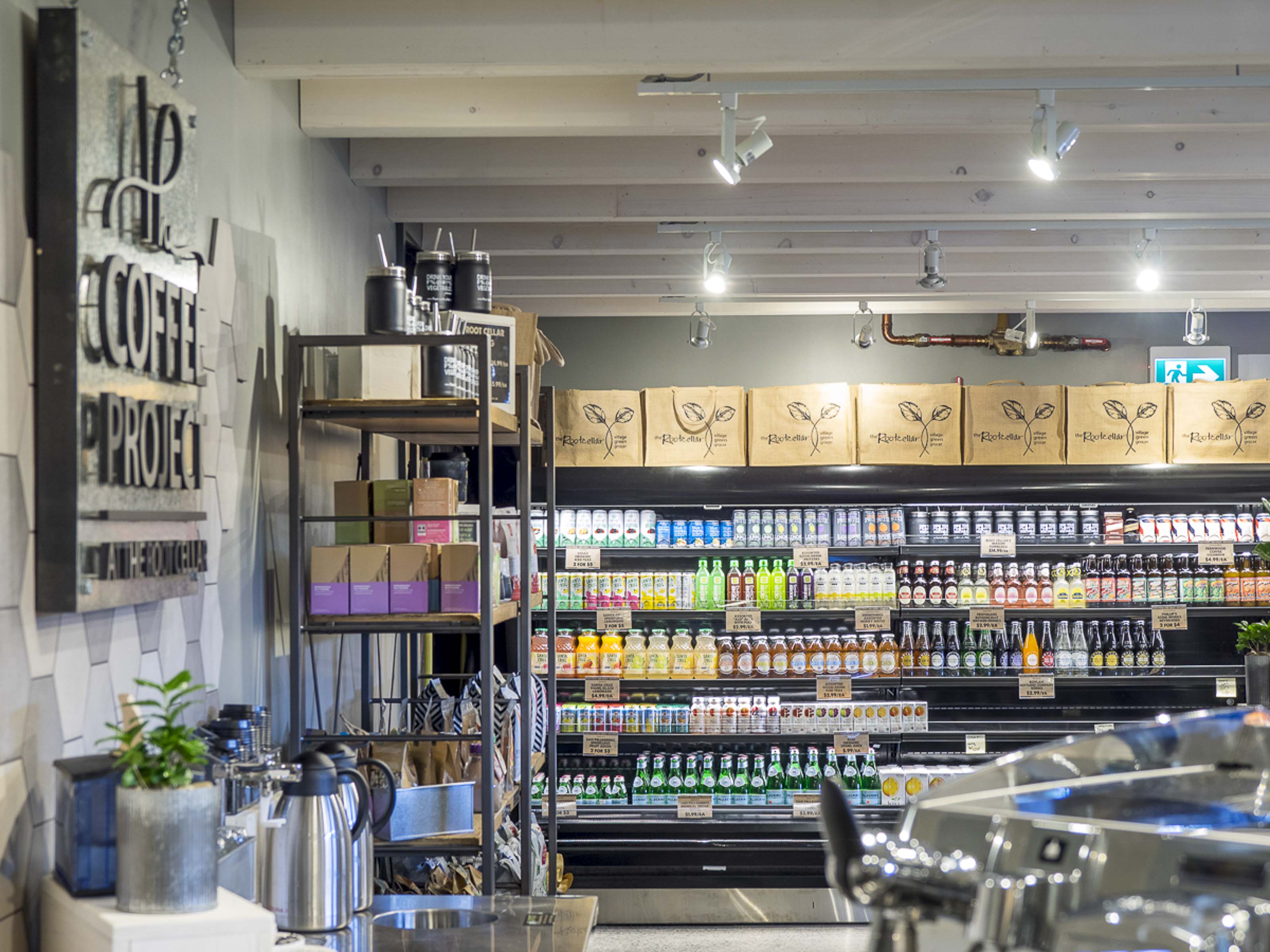 Coffee shop retail area construction Victoria BC - The Coffee Project commercial renovation by Outlook Project Management featuring beverage coolers, product shelving, and modern retail cafe design