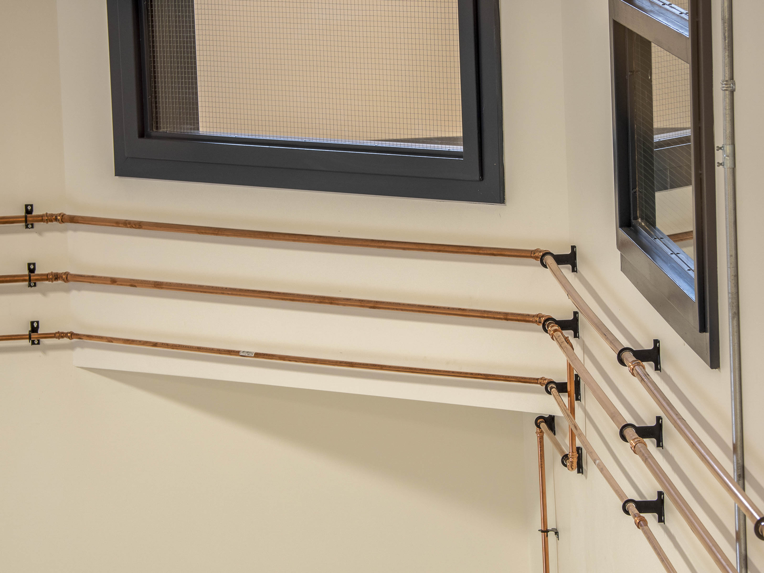 Custom copper piping installation Victoria BC - Outlook Project Management Discovery Coffee roastery featuring decorative plumbing details, industrial design elements, and warehouse renovation craftsmanship