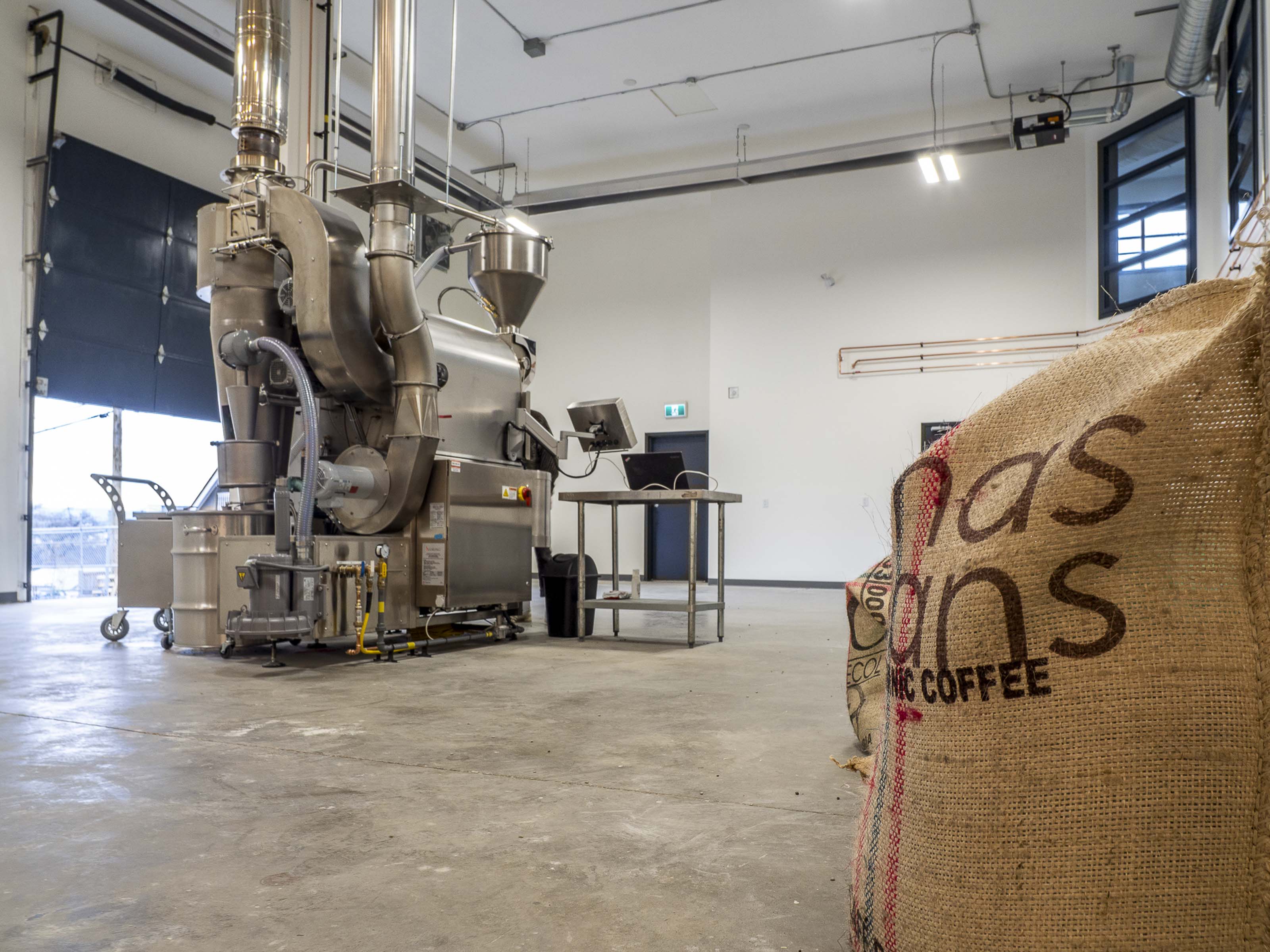 Modern employee kitchen renovation Victoria BC - Outlook Project Management Discovery Coffee warehouse remodel featuring marble countertops, light wood cabinetry, and premium office finishes