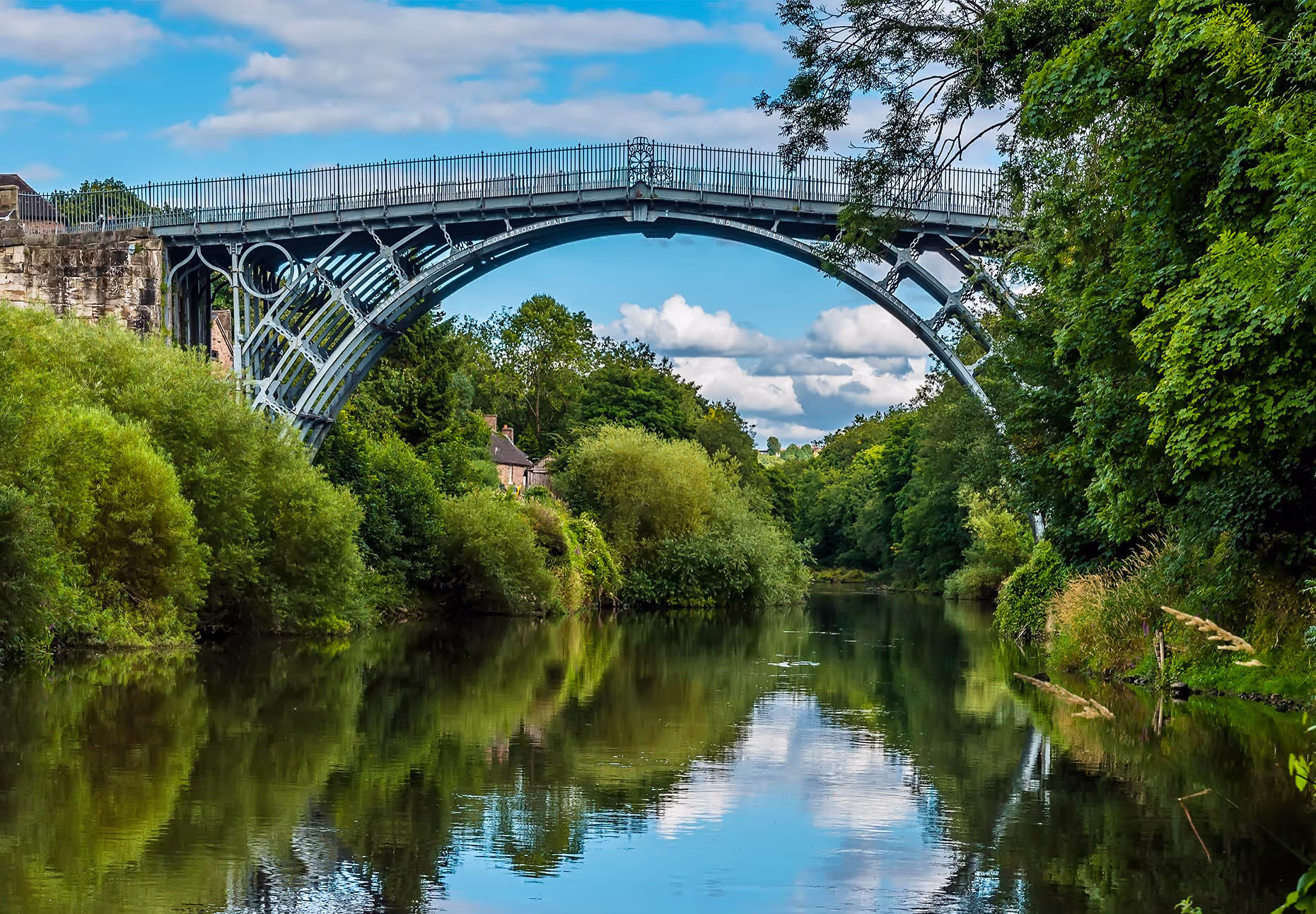 The Iron Bridge spanning over a river and green bushes.