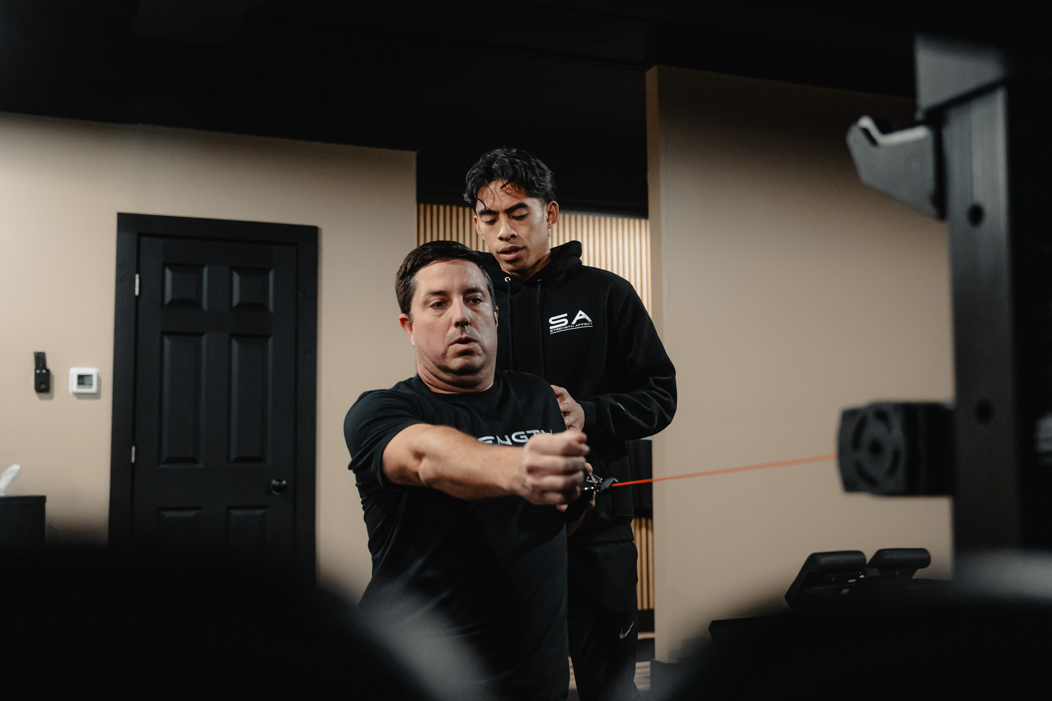 Client building strength under coaching at Strength Affect