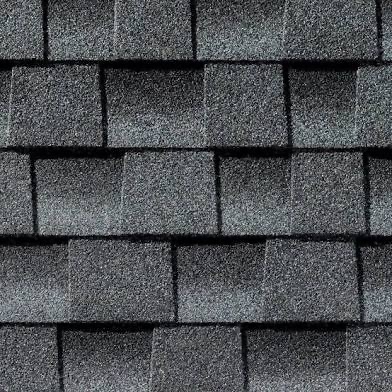 Gray asphalt shingles arranged in rows on a rooftop.