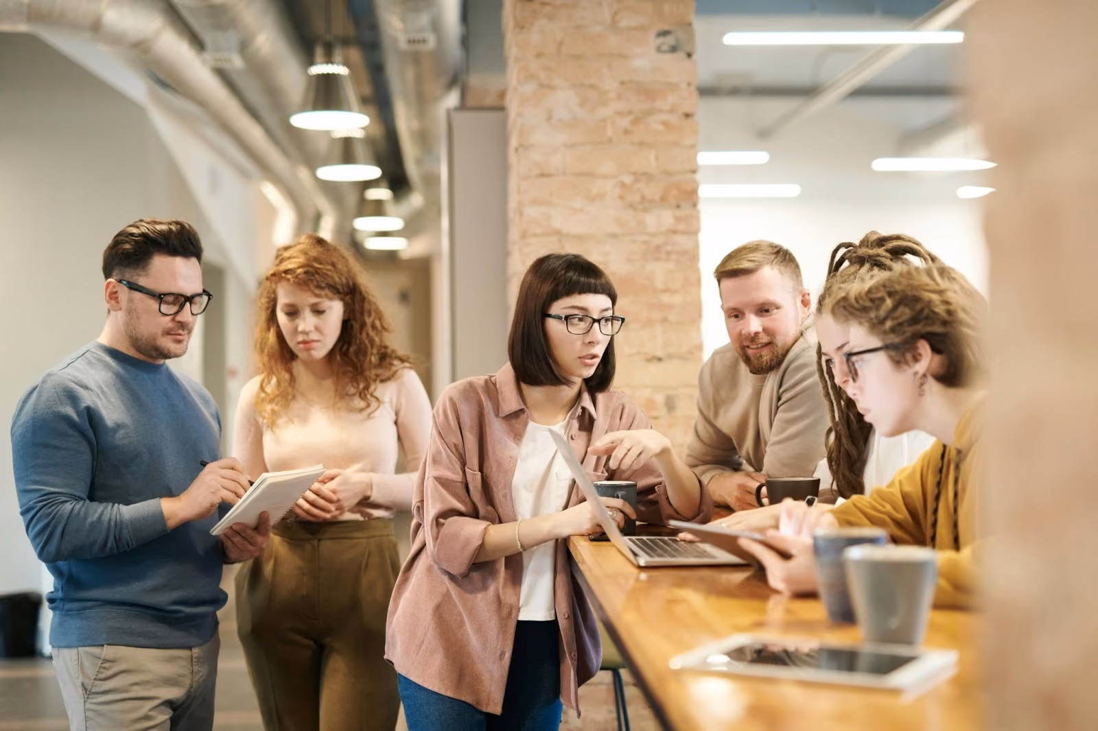 A group of employees collaborating and talking in an office.
