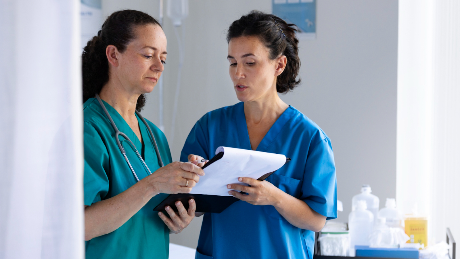 A doctor reviews employee absence data on a laptop to support the employee absence management process.