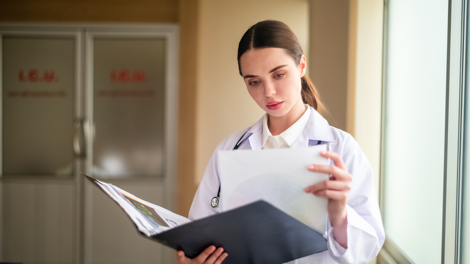  A healthcare worker reviews medical charts to understand causes of absenteeism in the workplace, including illness-related absences.