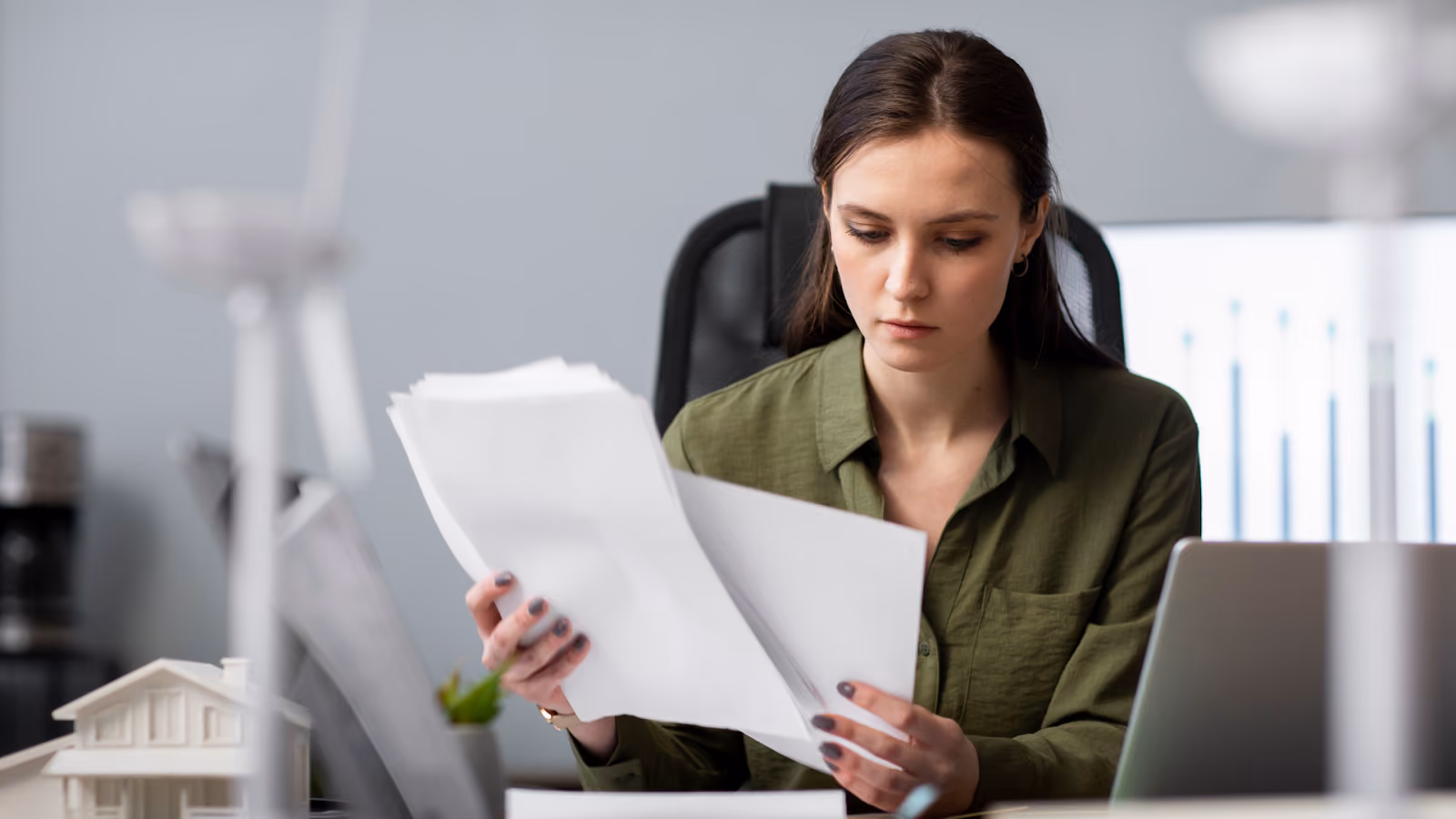 A woman reviews staffing math and pay rules for 24-hour coverage before publishing a 24/7 schedule.