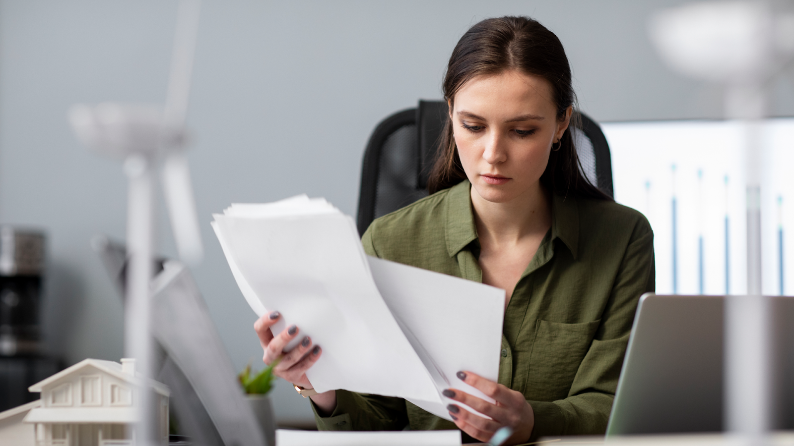 A woman reviews staffing math and pay rules for 24-hour coverage before publishing a 24/7 schedule.