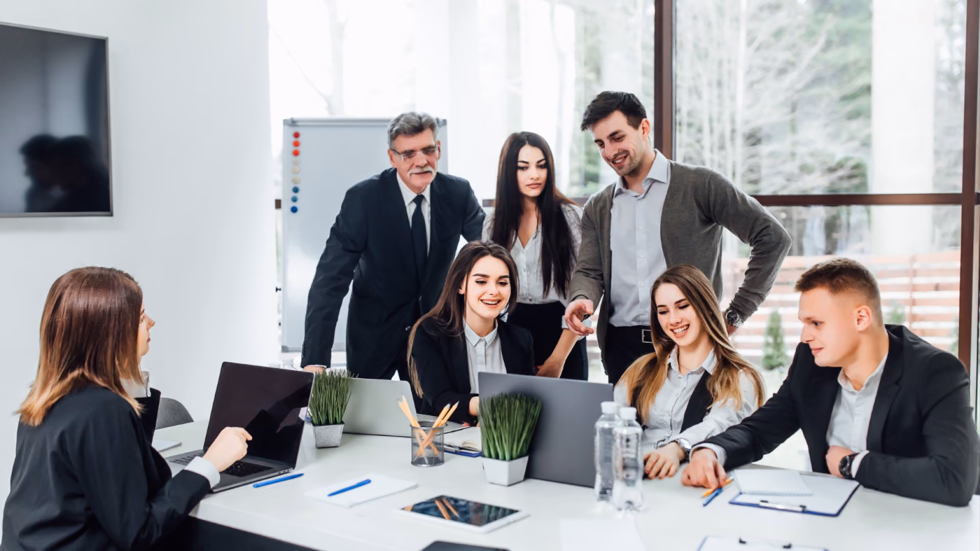 A group of professionals gathered around a table discussing what shift swapping means and how it works.