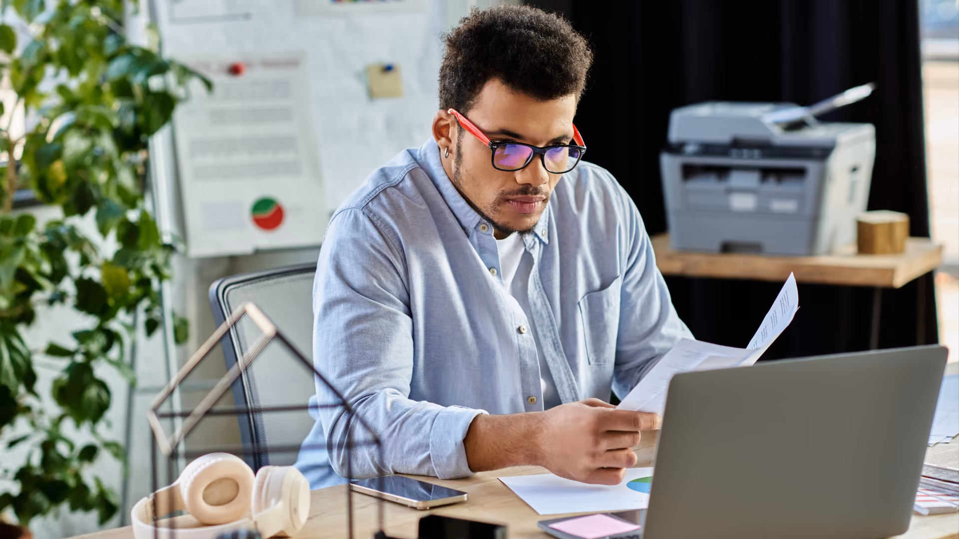 A professional using a laptop and tablet to learn how to solve scheduling problems beyond software.