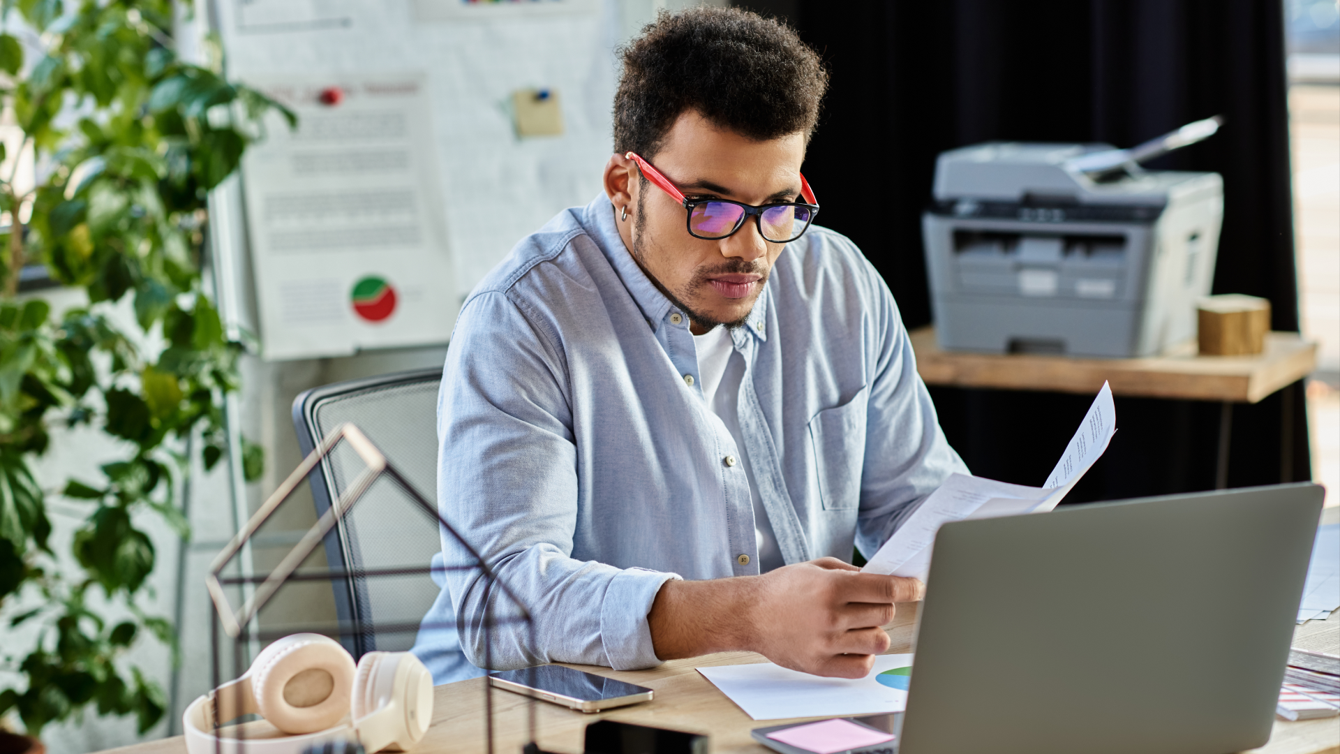 A professional using a laptop and tablet to learn how to solve scheduling problems beyond software.