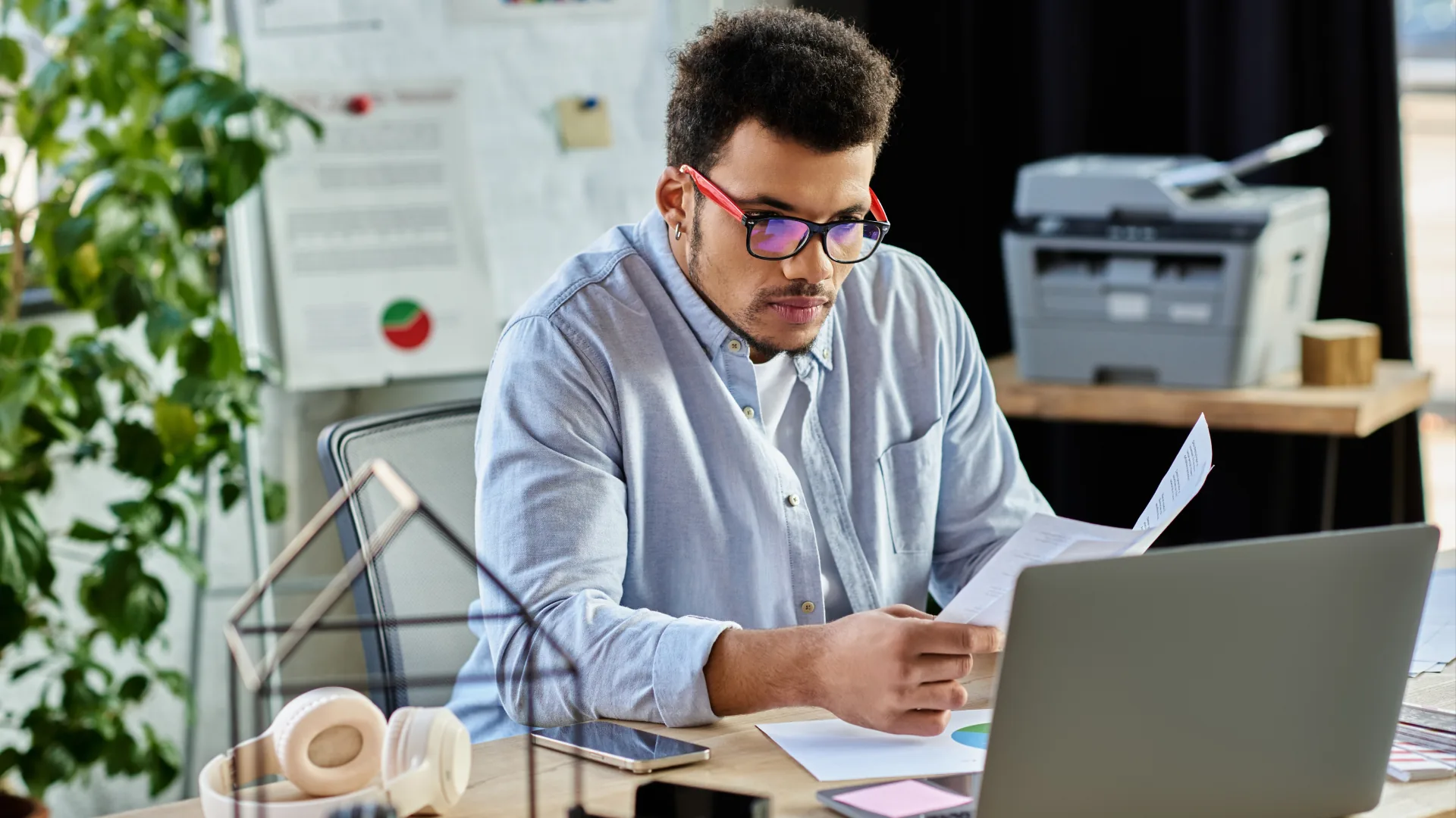 A professional using a laptop and tablet to learn how to solve scheduling problems beyond software.