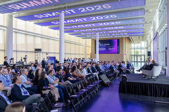Healthcare leaders speak onstage to a large audience at the Rezilient Health Summit 2026.