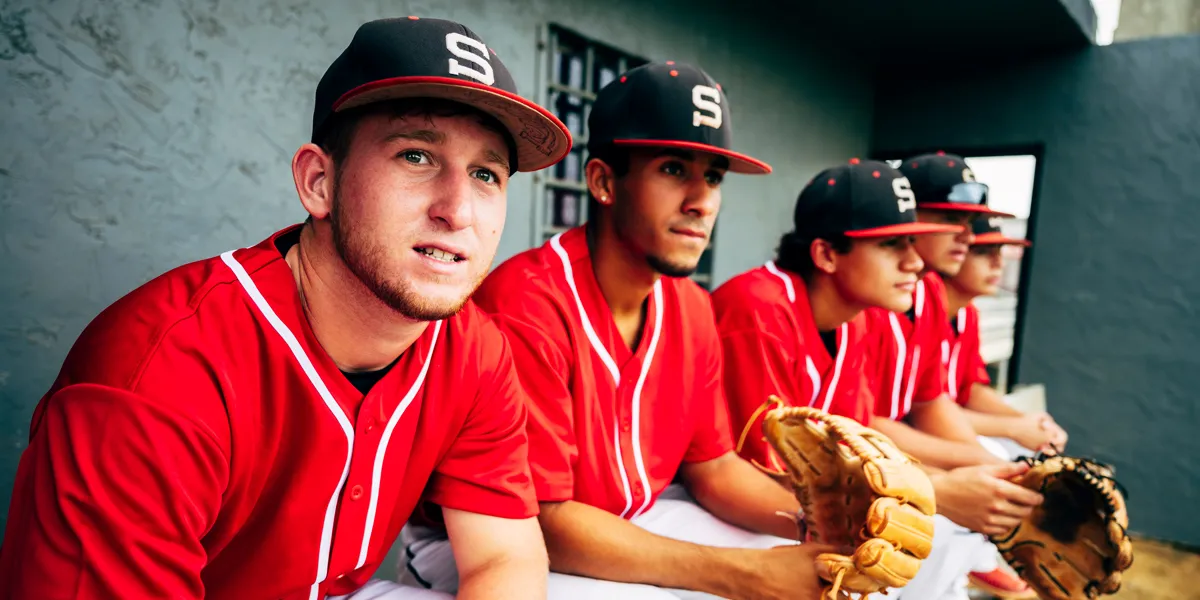 Players in baseball dugout