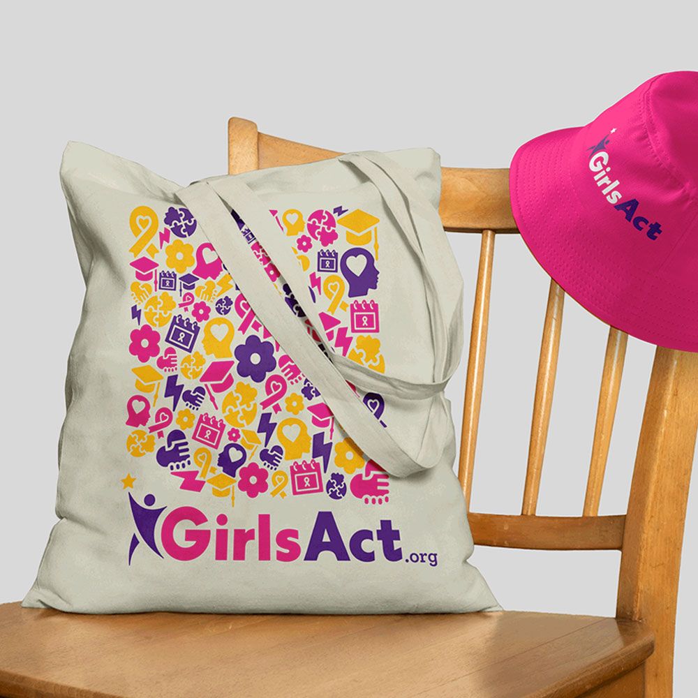 A mockup of a Girl's Act design of a totebag and bucket hat by Kristina Gabrielyan
