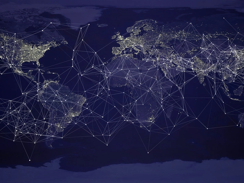 Mapa mundial nocturno que muestra ciudades iluminadas conectadas por líneas de red