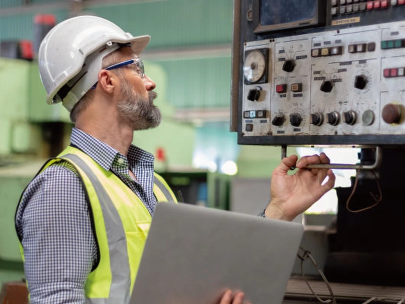 Man monitoring production equipment for stops