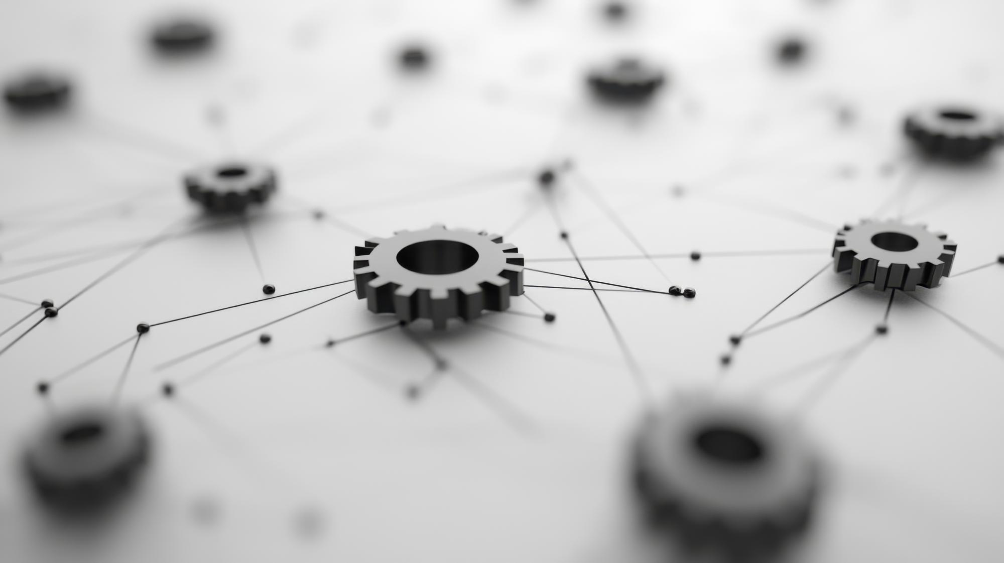Szare metalowe tryby połączone cienkimi liniami tworzące sieć na jasnym tle.