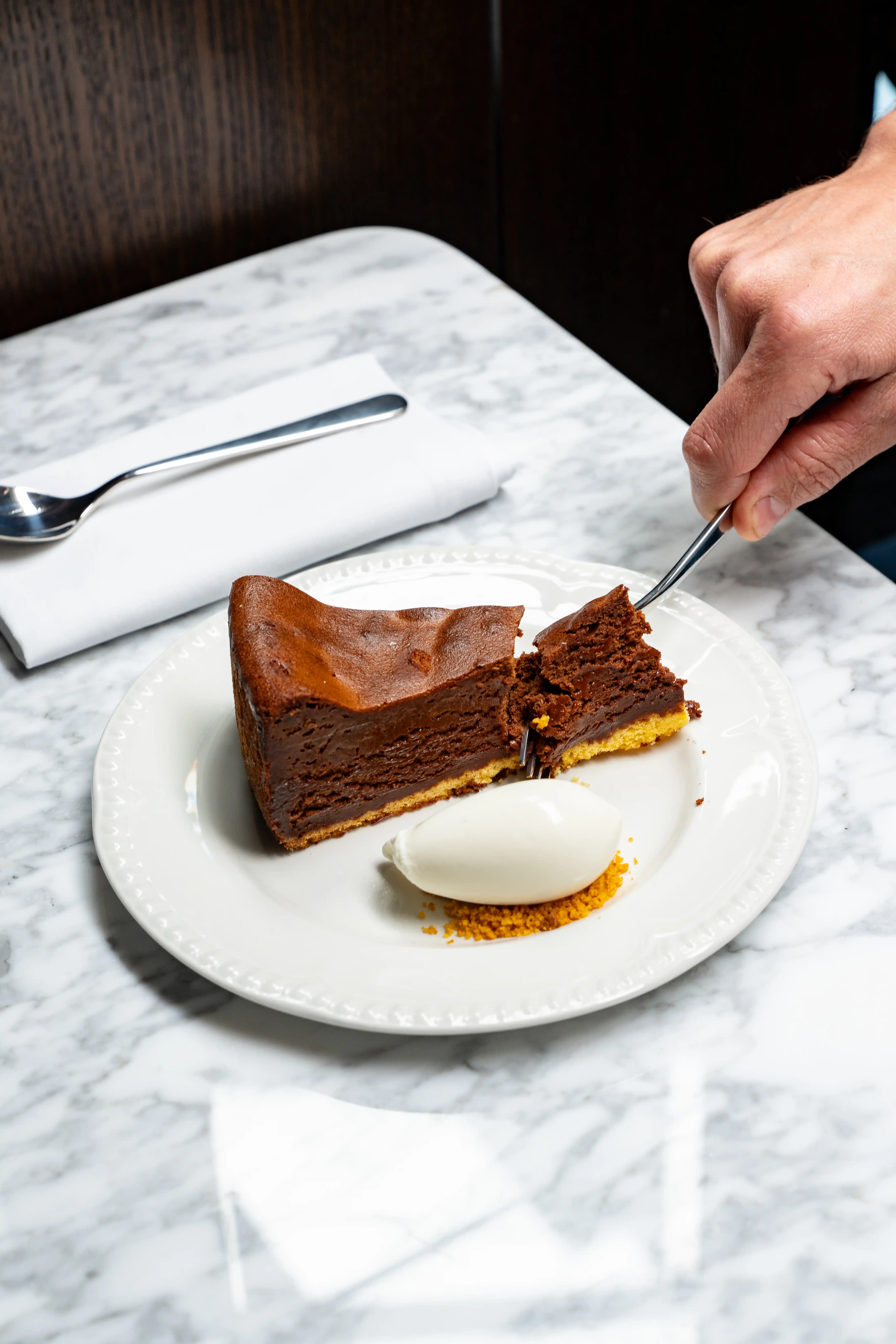 Chocolate cake slice with ice cream - Henri Restaurant Henrietta Hotel