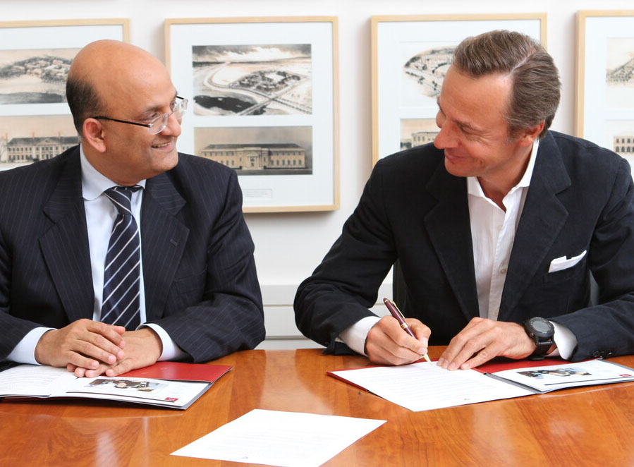 Ernesto Bertarelli signing a document