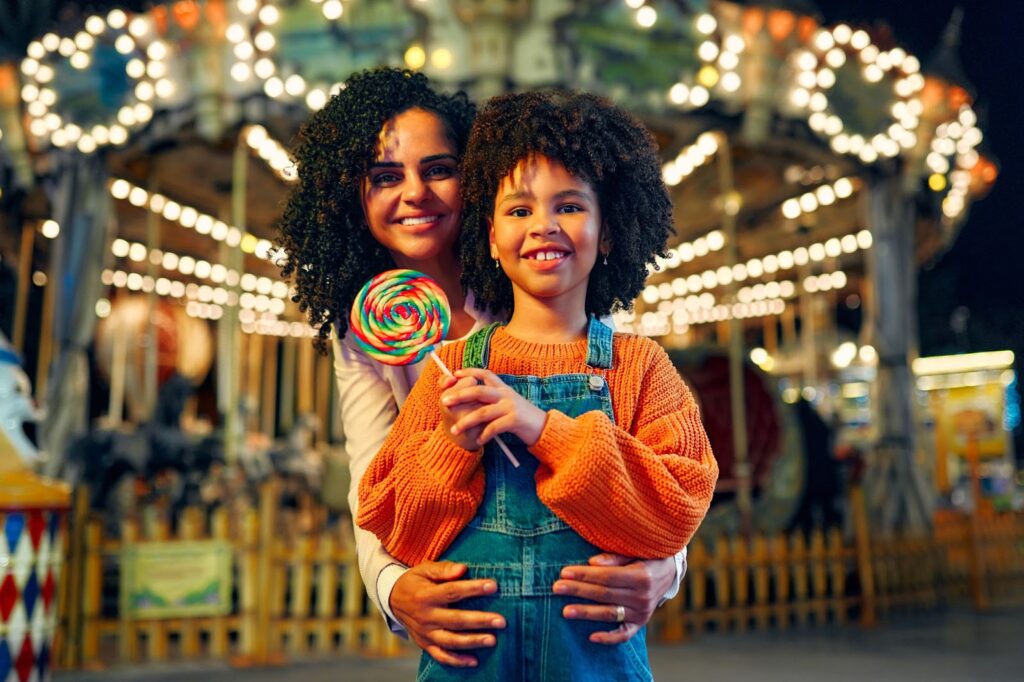 kid and her mom having fun at the amusement park