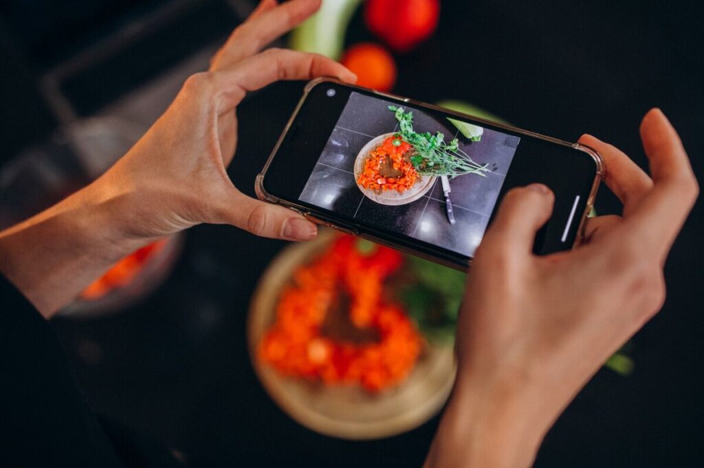 A person taking a picture of food for instagram