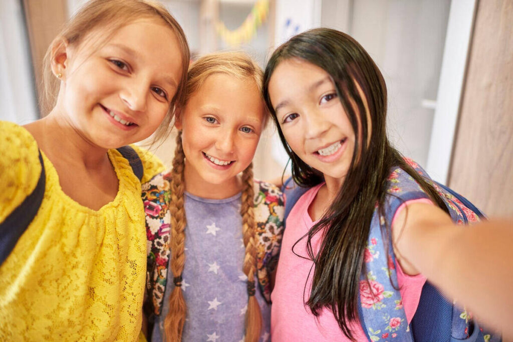 young girls posing for their first day back in school