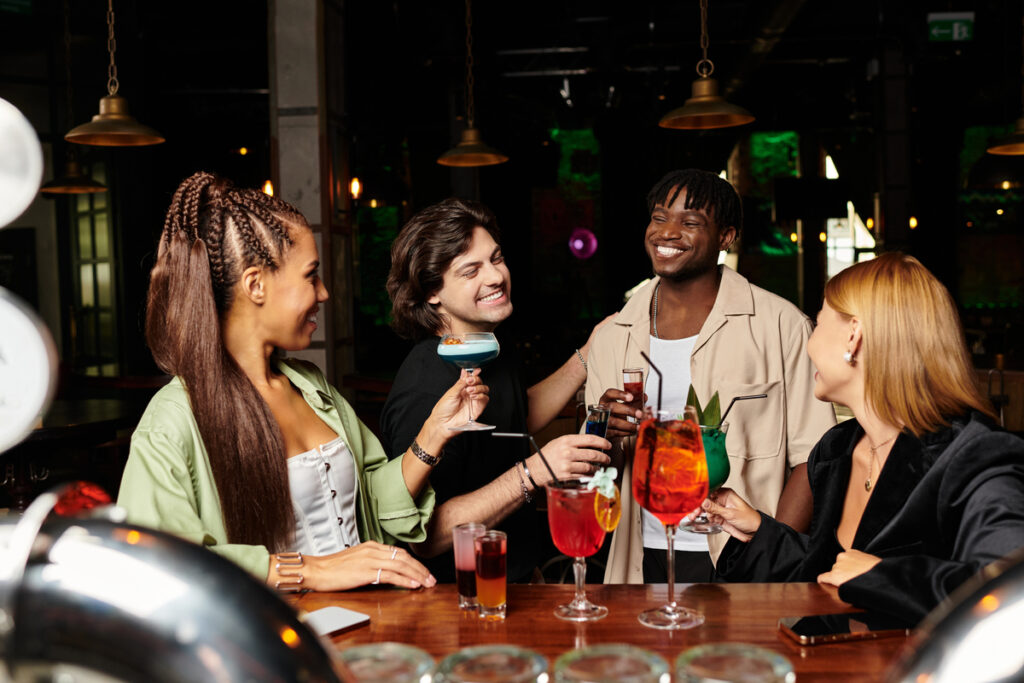 young professionals enjoying cocktails and laughter at a night out.