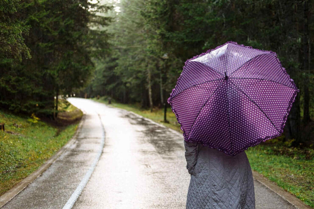 Having wanderlust during a rainy weather under an umbrella