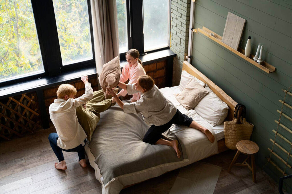 family having a pillow fight at the staycation