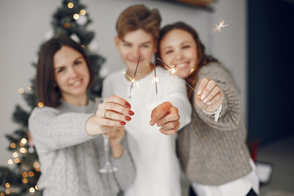 a family posing for picture with sparkler