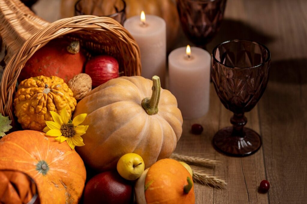 pumpkins with candles on a table