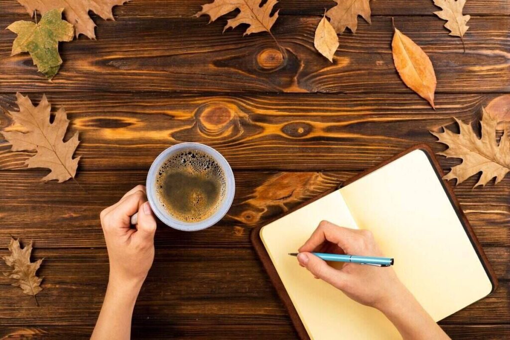 A person writing instagram captions in a journal