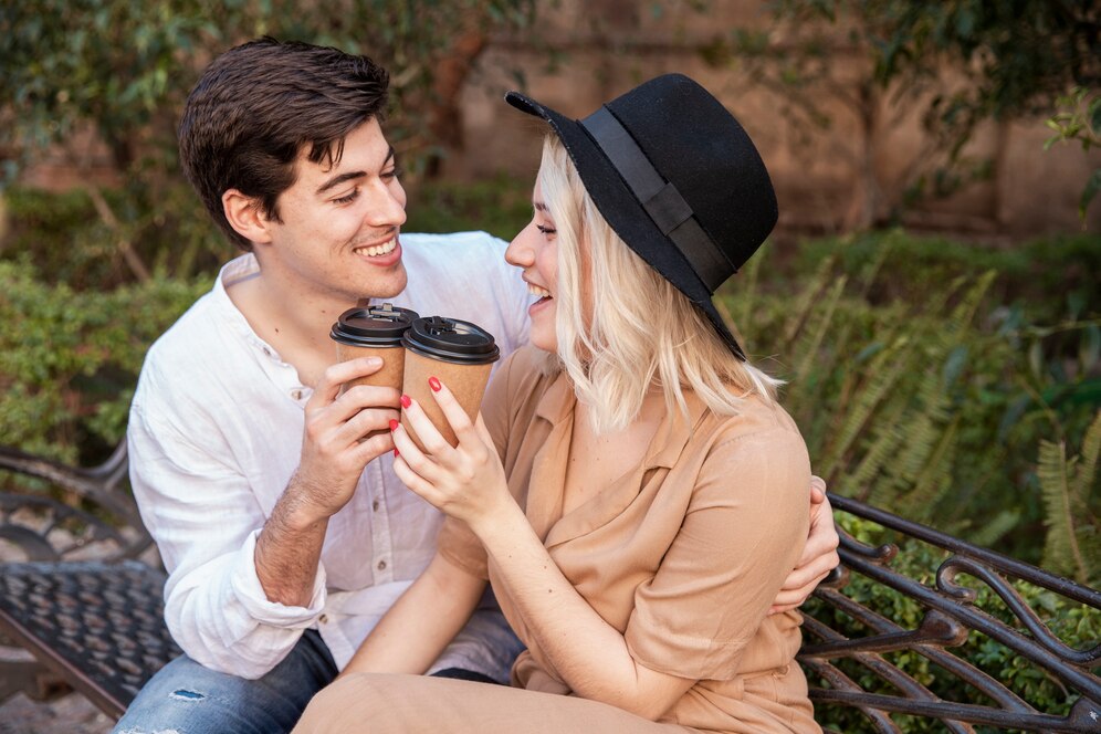 a couple enjoying a sweet coffee outside