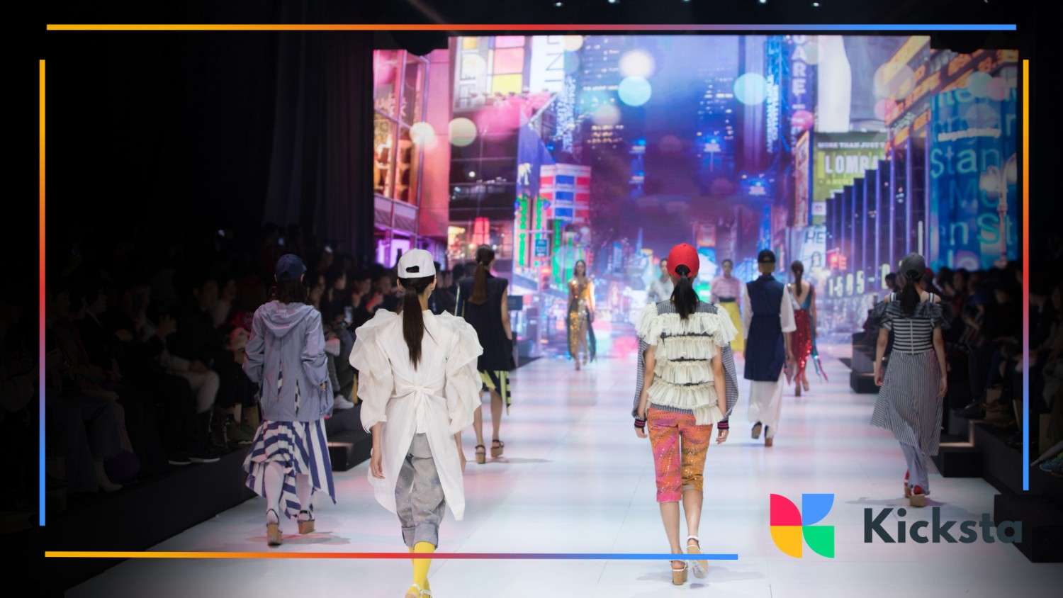 Models walking down a fashion show runway, with vibrant digital city lights and a cheering audience in the background