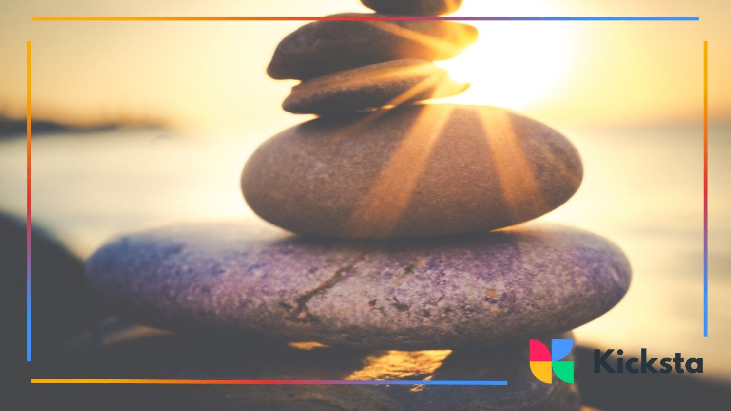 Stacked smooth stones bask in warm sunset light, symbolizing balance and calm