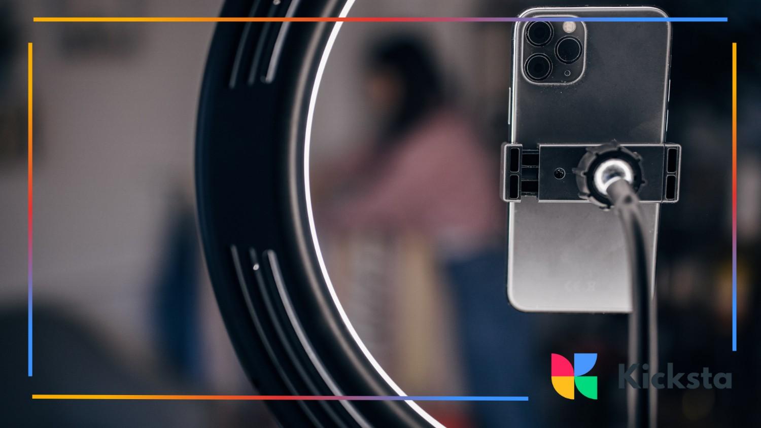 A sleek iPhone setup behind a ring light, ready for content creation. This image reflects the polished, high-production aesthetic favored by luxury beauty and fashion brands on Instagram.