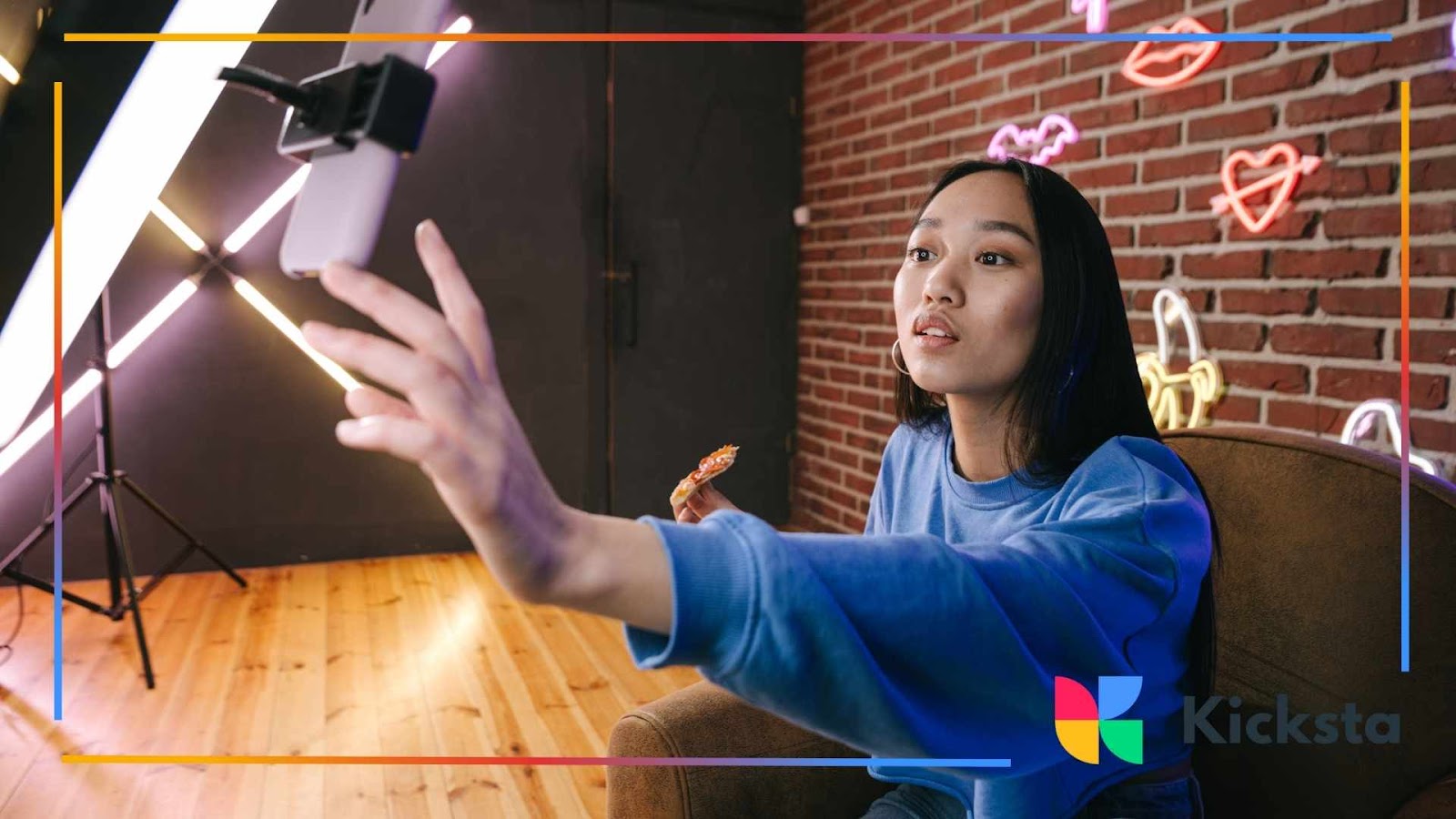 Content creator recording Instagram video in modern studio with neon lights, smartphone tripod, and professional lighting setup.