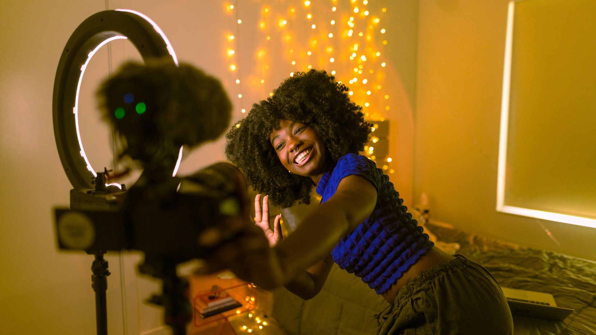Photographer reviewing camera next to laptop displaying Instagram feed, symbolizing content creation, social media marketing, and digital photography workflow.