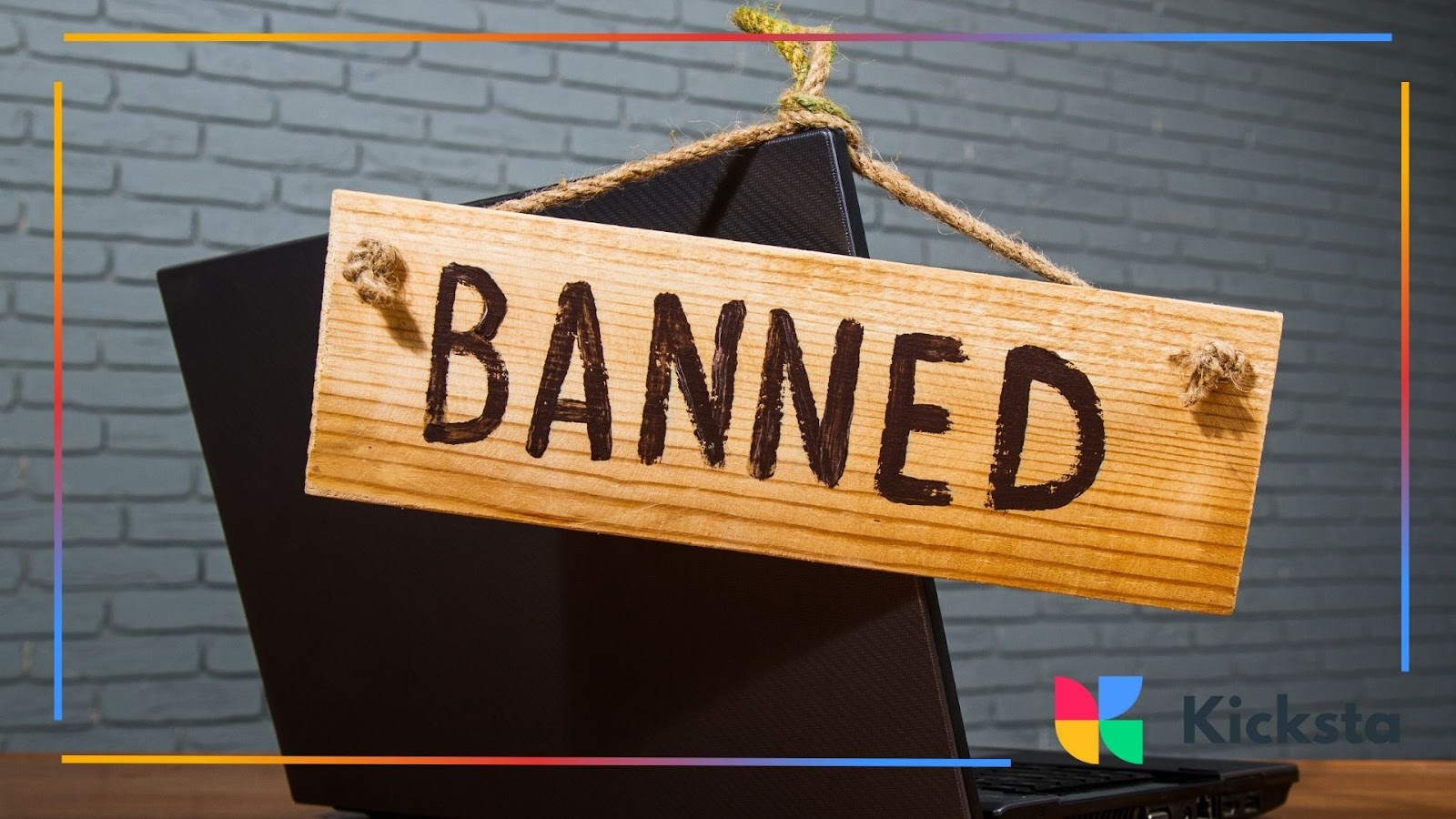 Wooden sign with word banned hanging on laptop, symbolizing social media ban, account suspension, and online restrictions.