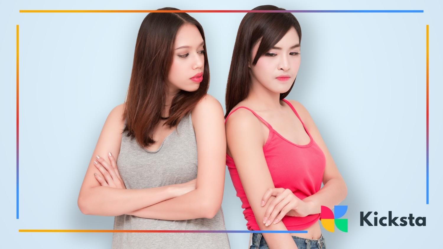 Two girls facing away from each other with crossed arms