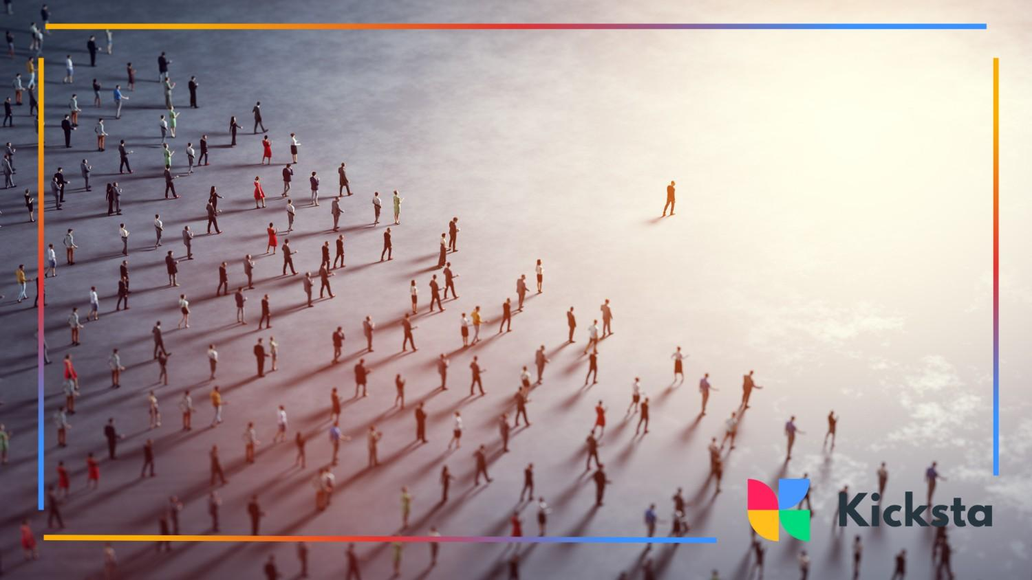 Aerial view of a large group of people walking in the same direction with one person leading in front.