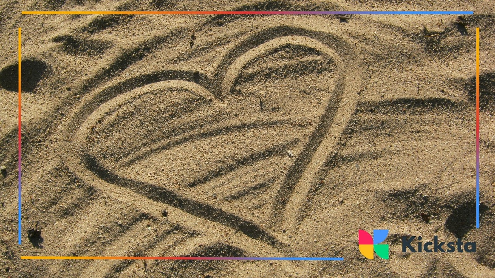A heart etched in the sand captures a fleeting yet beautiful expression of love, simple and sincere.
