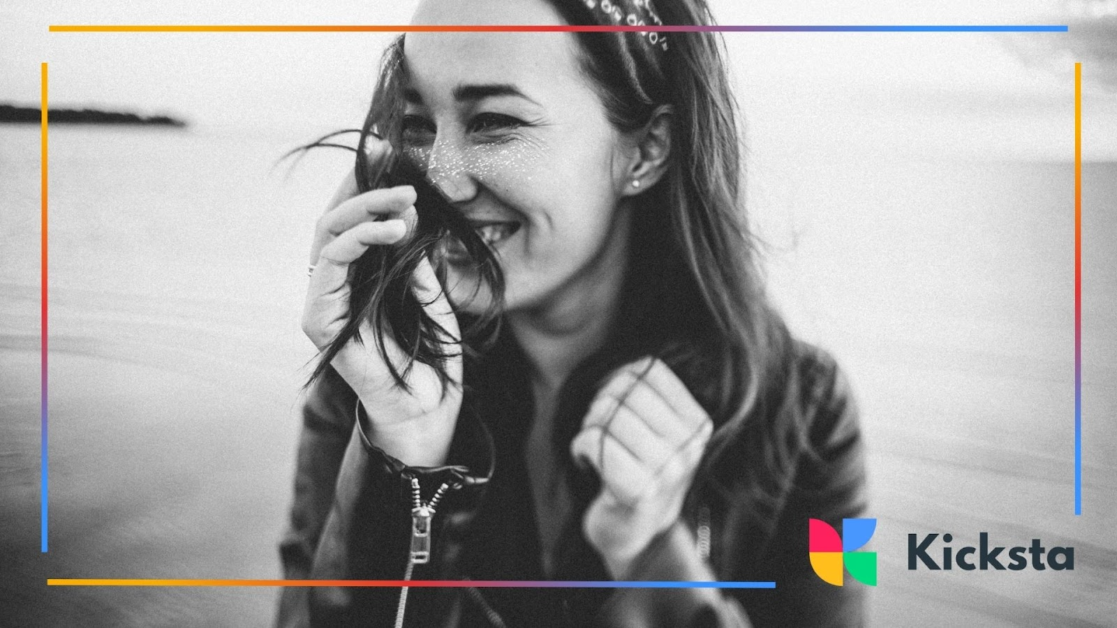 Woman laughing and hiding her smile with her hair
