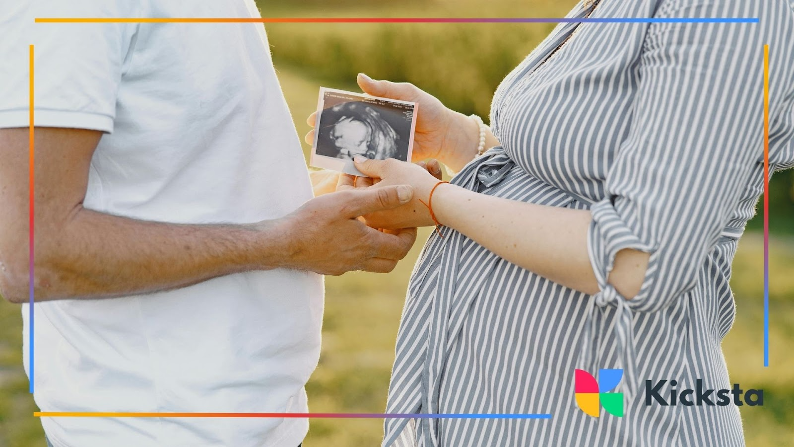 Pregnant couple holding an ultrasound photo