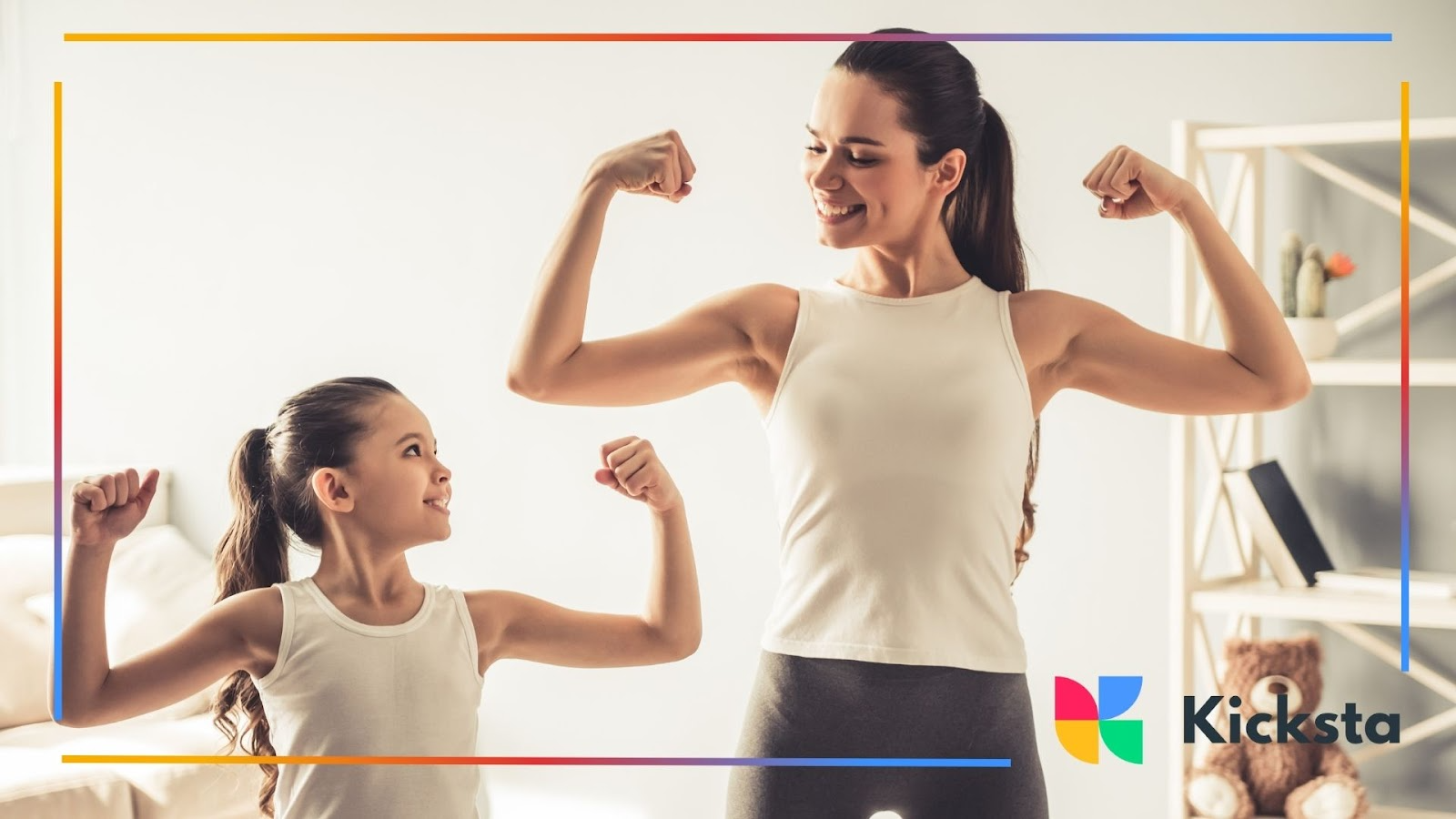 A mother and daughter smiling while flexing their arms side by side indoors
