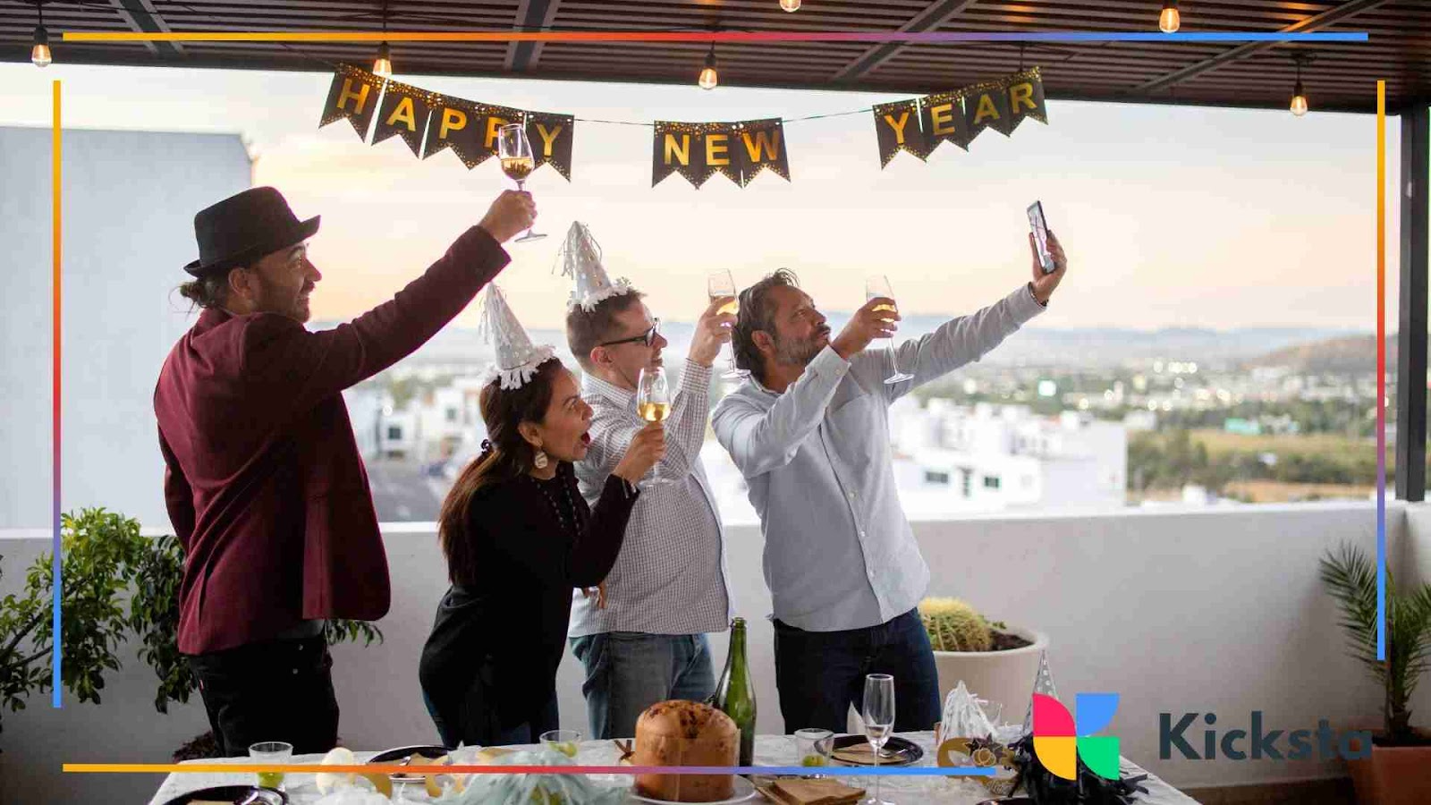 Group celebrating New Year’s Eve with party hats and champagne