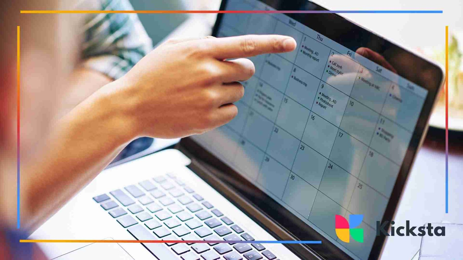 Close-up of person pointing at digital content calendar on laptop