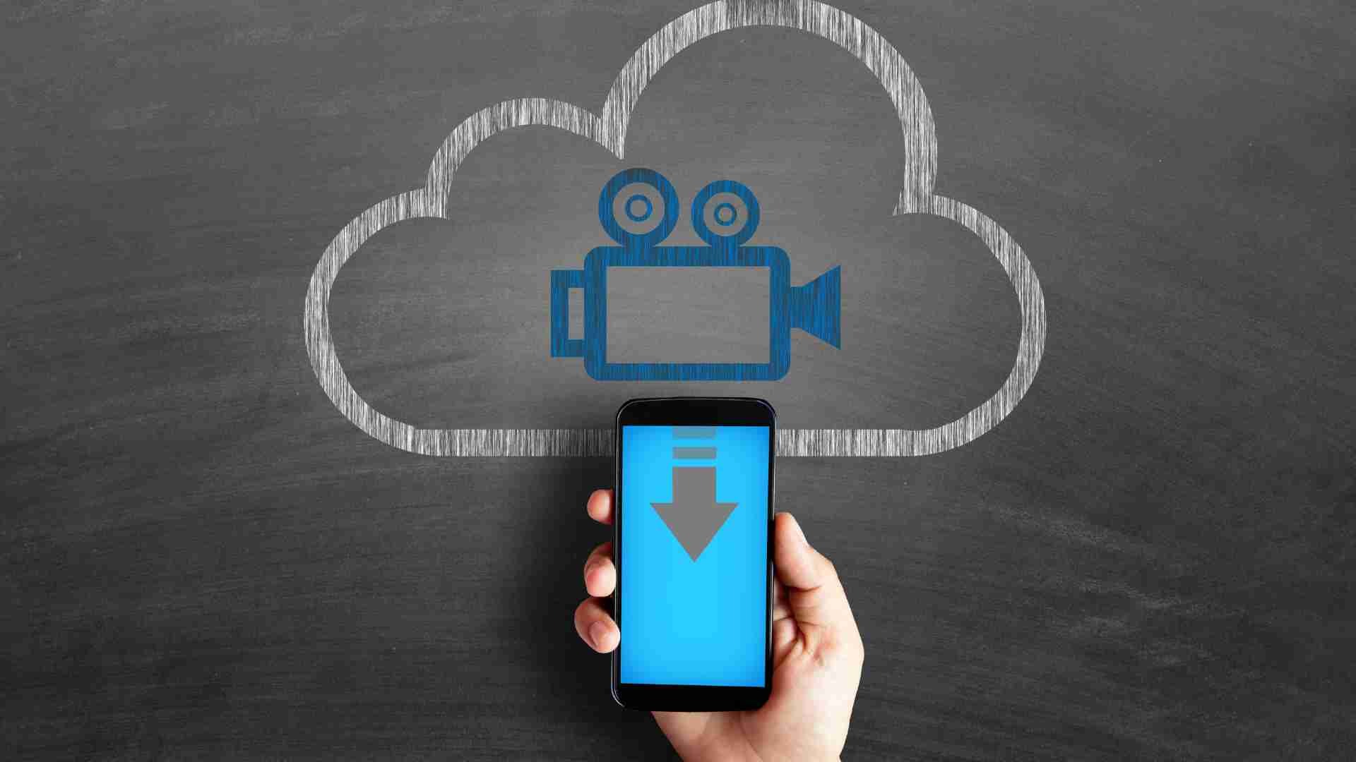 Hand holding smartphone with cloud download icon for Instagram videos.