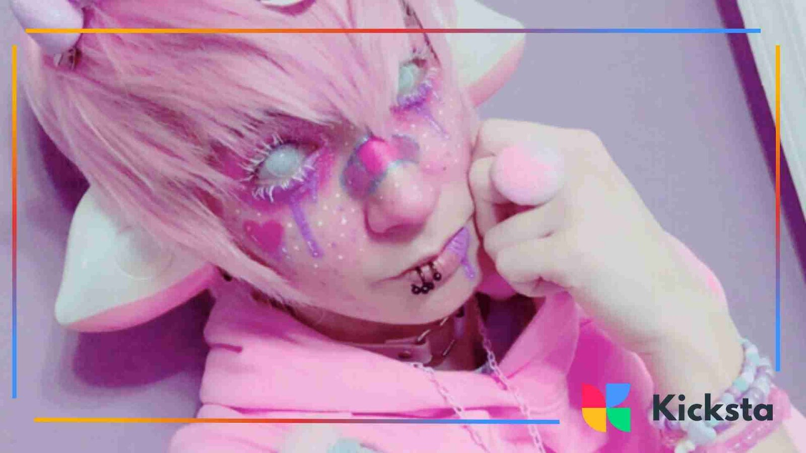 Cosplay-inspired look with pink hair, dramatic makeup, and fantasy accessories.